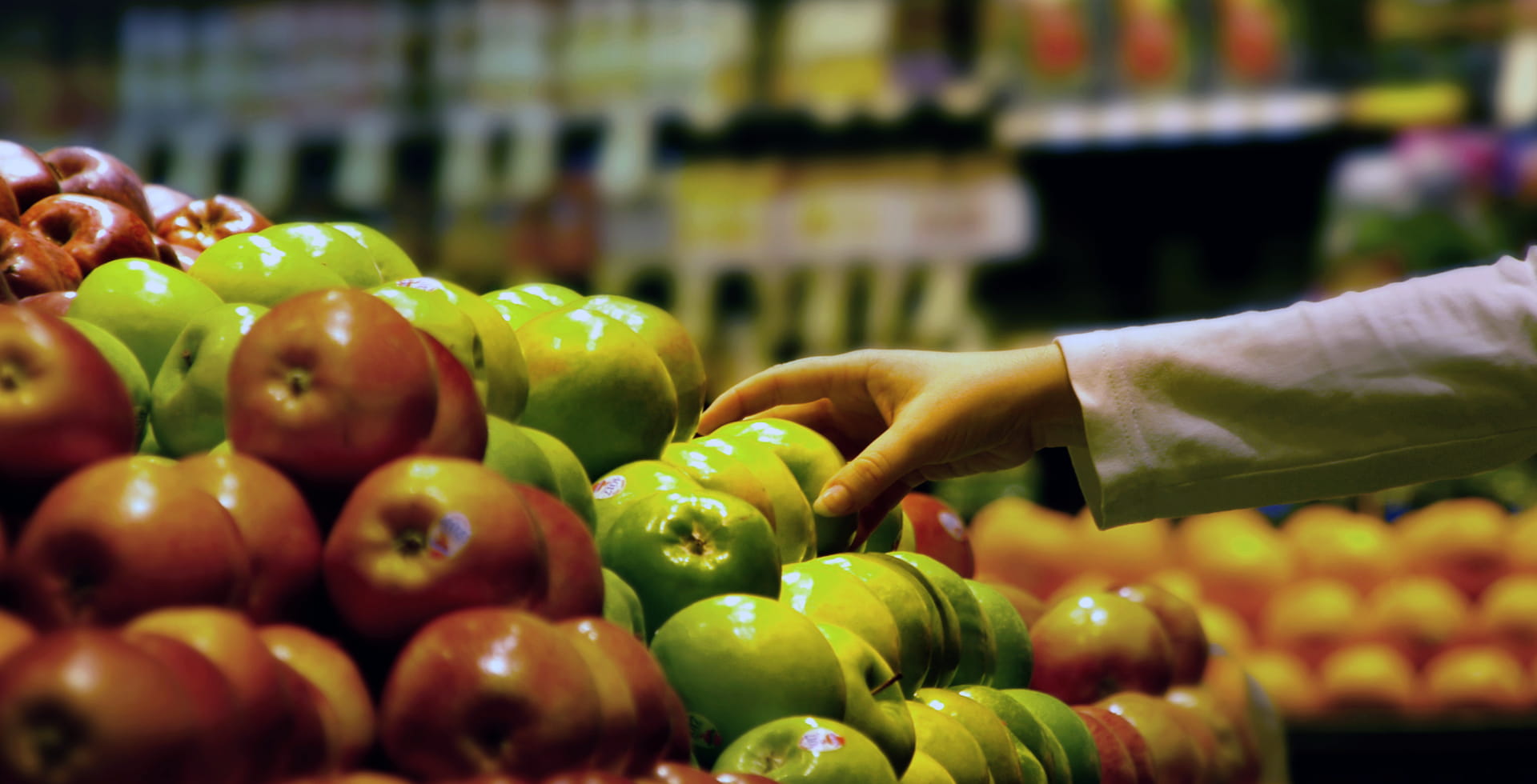 hand reaching for an apple